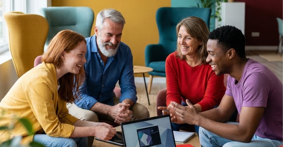 Four people in discussion during a community-focused market research session