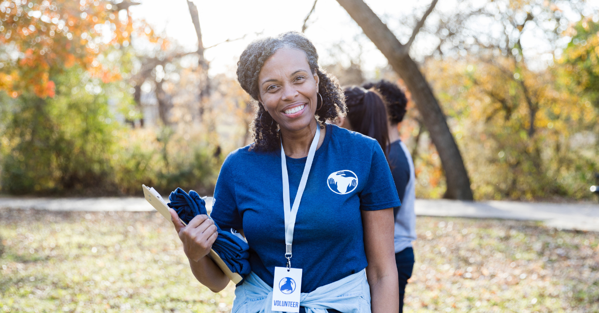 Researcher holding a clipboard while conducting fieldwork in a community setting