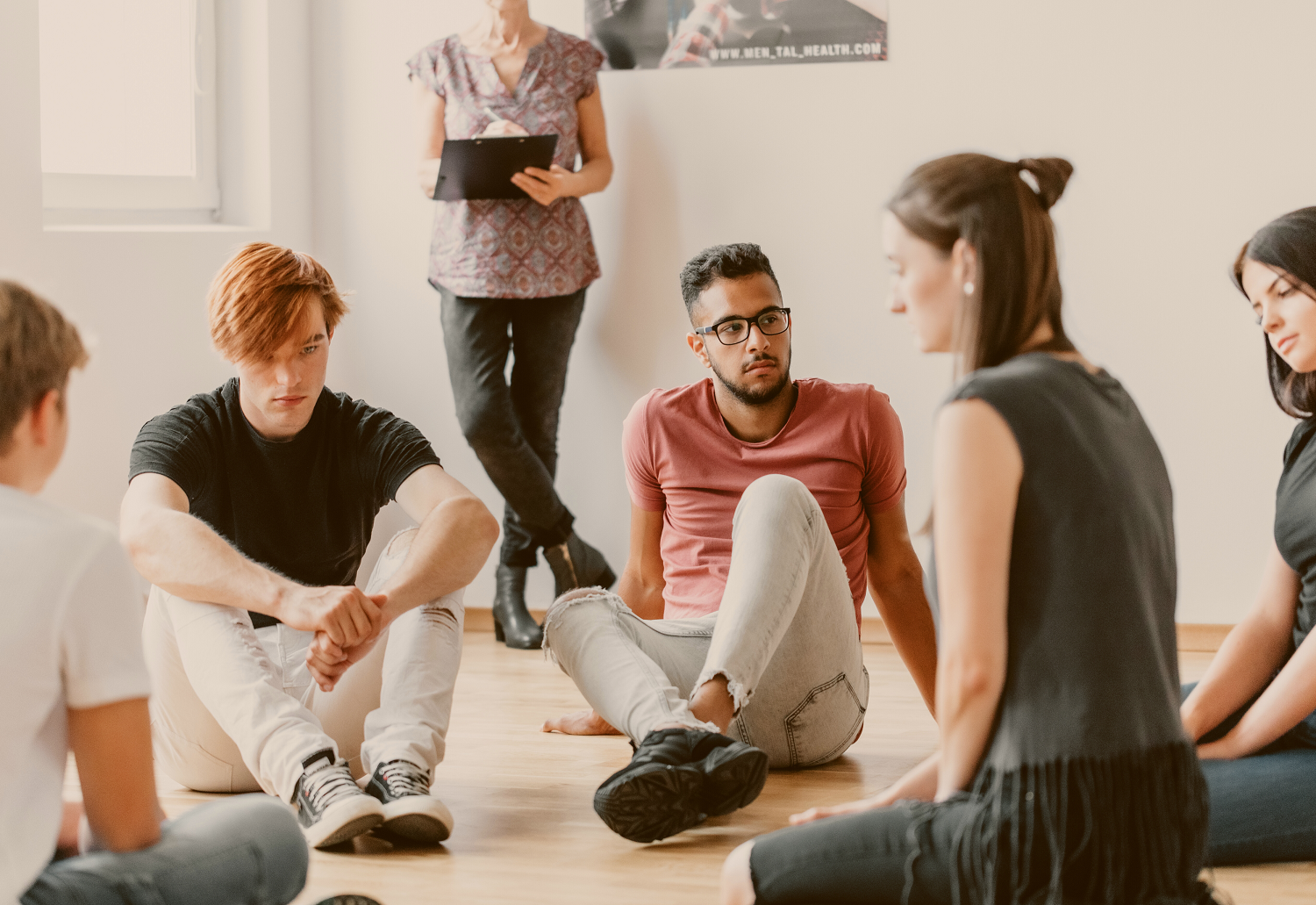 A group of focus group participants sitting in a circle, representing the debate between recruiting participants for research online. 