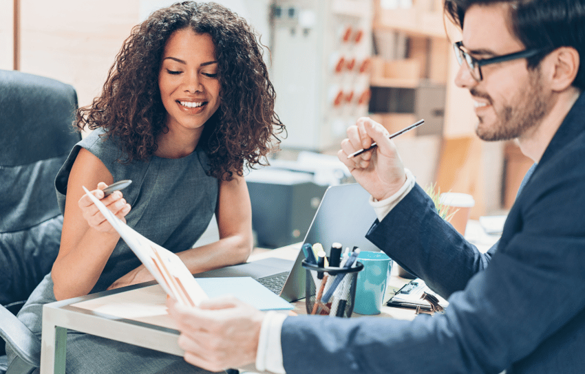 A man talking to a woman about UX research representing a woman with a tablet talking to other people, representing how to recruit for ux research