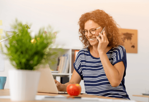 A market researcher on the phone speaking to a participant for their user research telescreen interview.