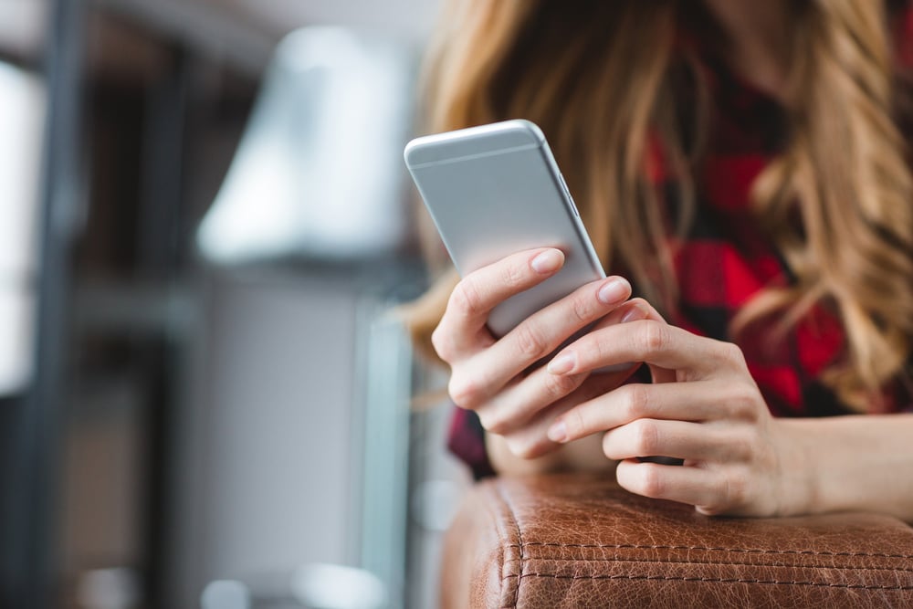 Young woman using social media, illustrating how researchers can recruit Gen Z participants through Instagram and TikTok
