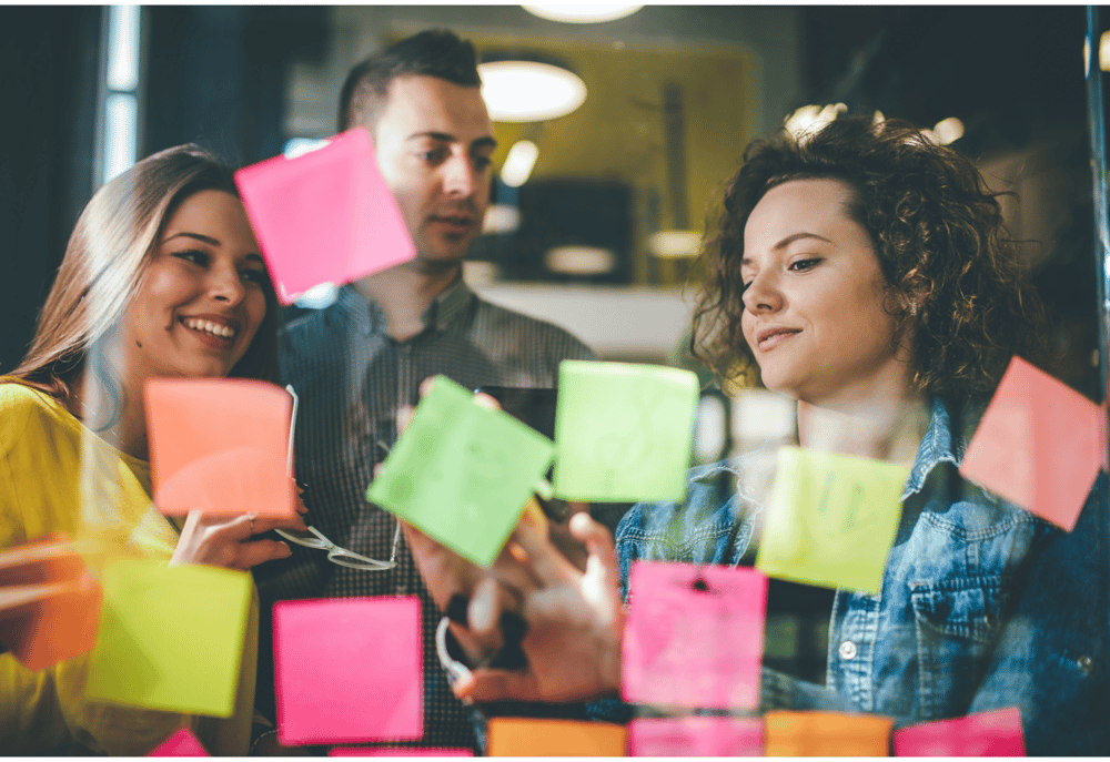 Focus group participants sharing ideas on post-it notes, representing ideas from a focus group recruitment agency.