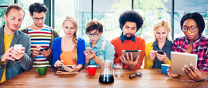 Group of millennials on their devices as part of millennial MROCs