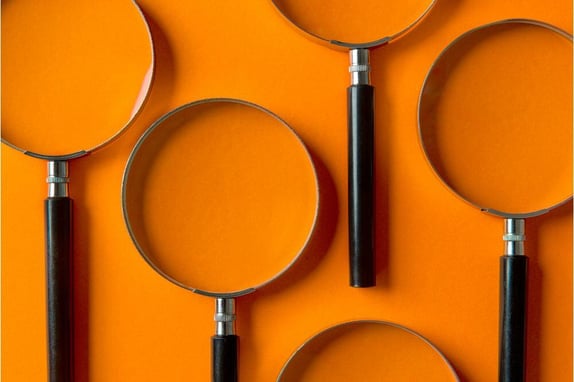 magnifying glasses on orange background