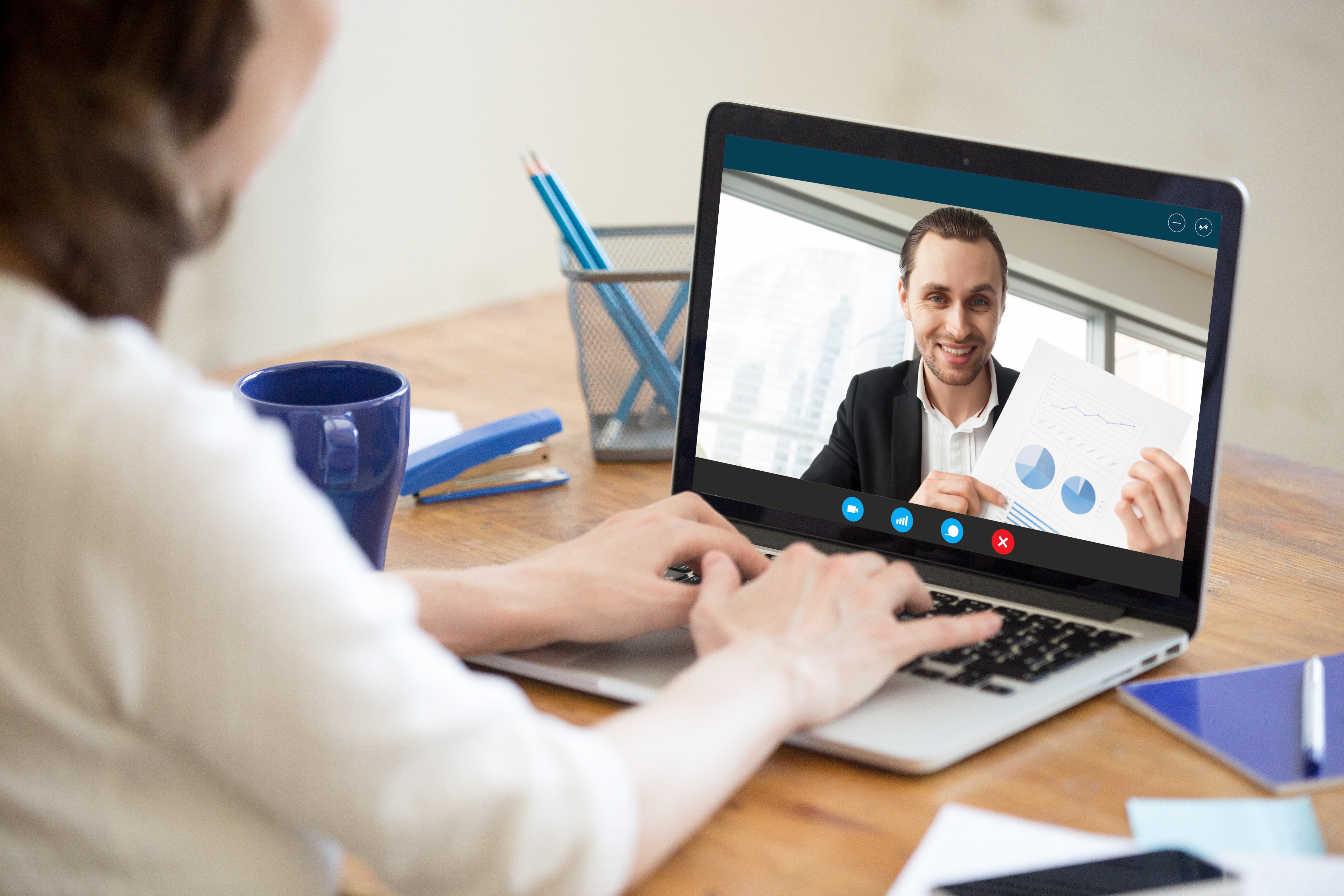 Two people on a video call comparing market research insight and data from a project