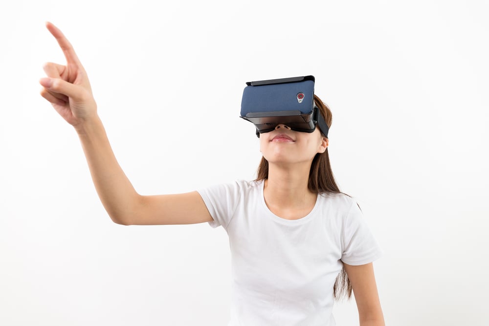 Woman wear with with VR device and finger touch in air as part of the future of market research