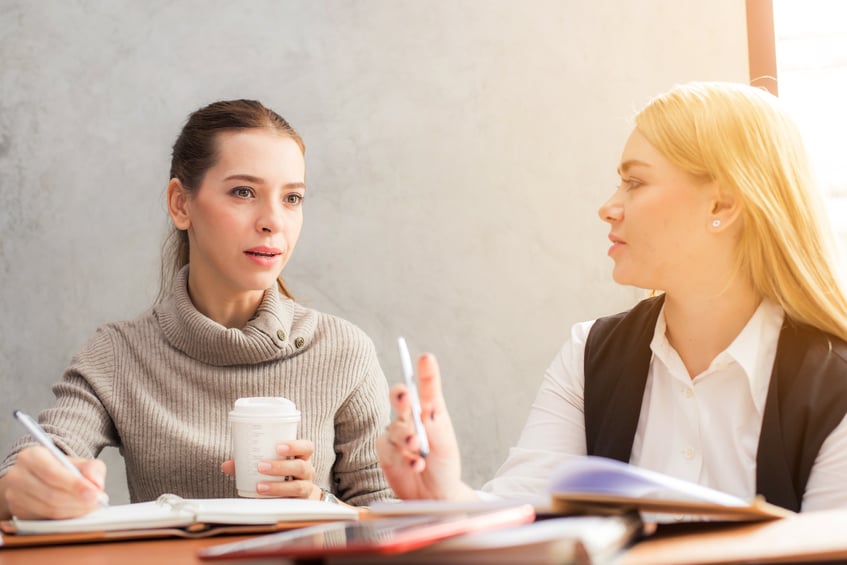 Two women taking part in face-to-face user testing, rather than remote user testing