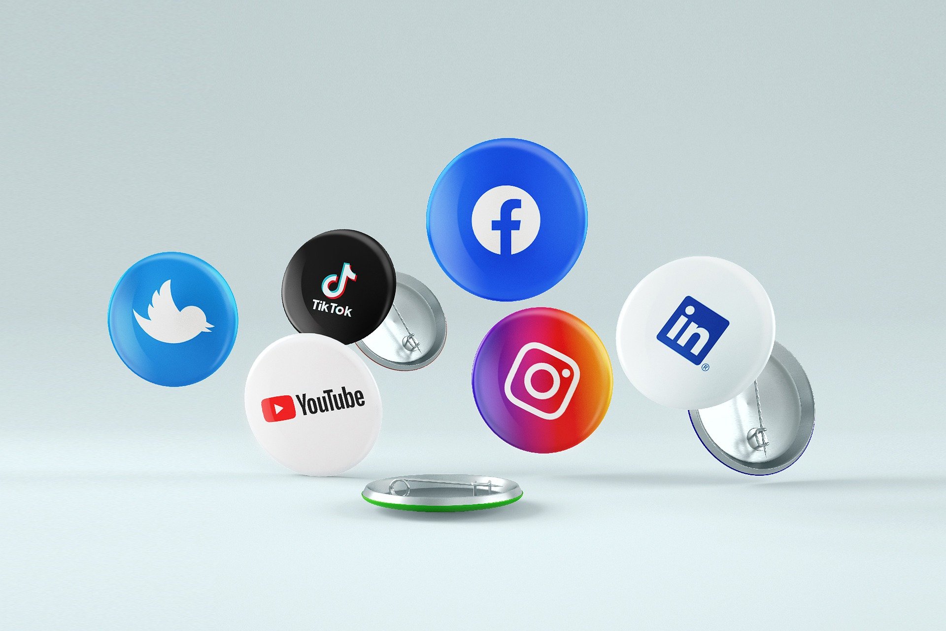 Social media icons on pin badges, demonstrating recruiting participants for media research.