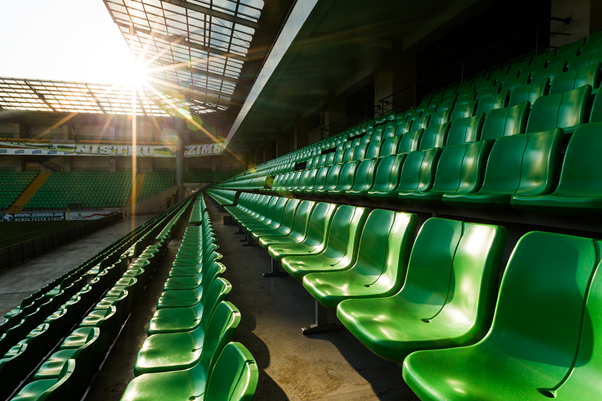 Green sports stadium chairs in rows, representing Angelfish Fieldwork's ethnographic market research case study