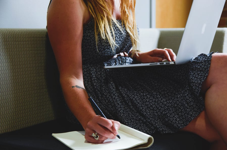 Student writing notes as part of Consumer Fieldwork