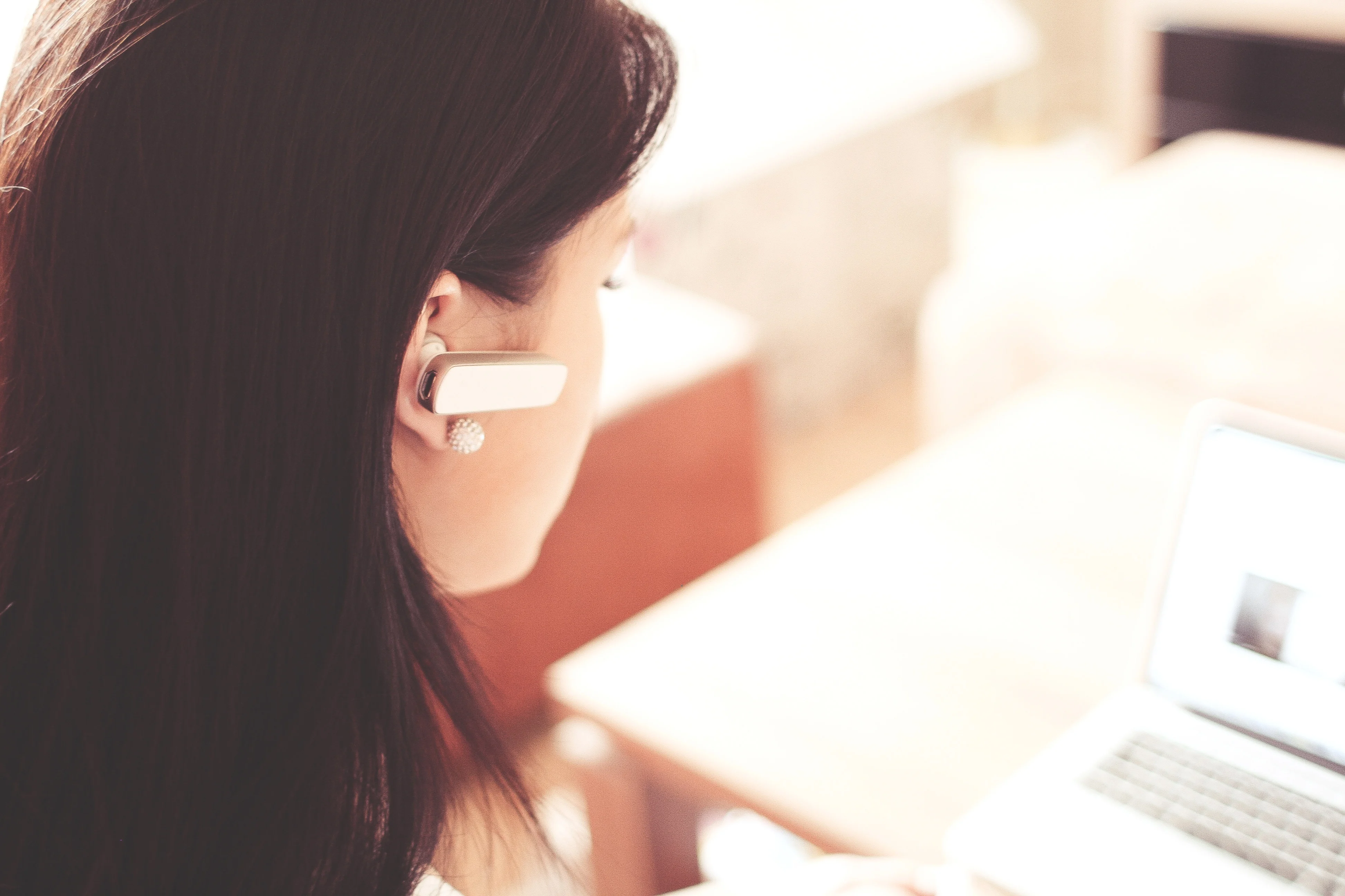 Female focussing on laptop while taking part in a market research online community