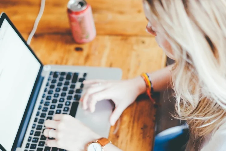 woman looking at market research data on her laptop