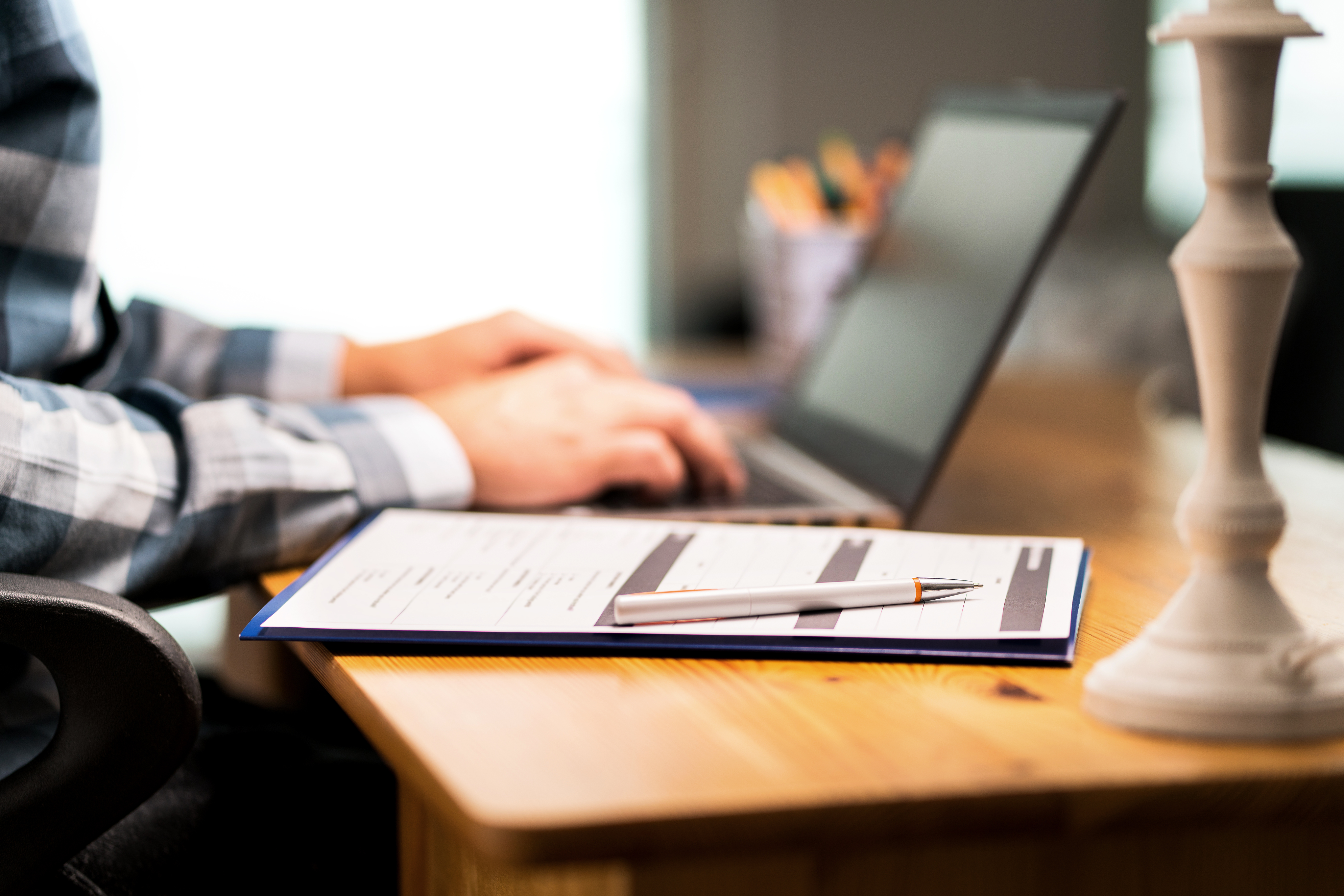 User research recruitment agency team member creating a screener on a laptop and clipboard.png