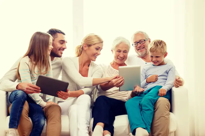 a large family looking at tablets demonstrating market research with children